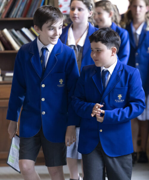 Two confident Ficino school boys, looking relaxed and walking together.