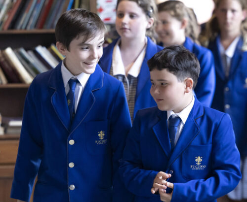 Two confident Ficino school boys, looking relaxed and walking together.