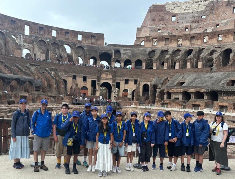 A group of Ficino School students standing in the Colosseum in Rome