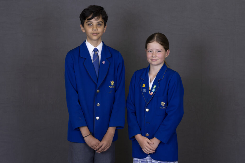 Two Ficino School students wearing blue blazers.