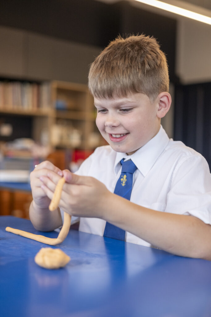 Boy making clay model