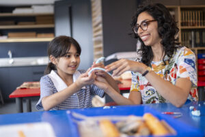 Girl and teacher working with clay