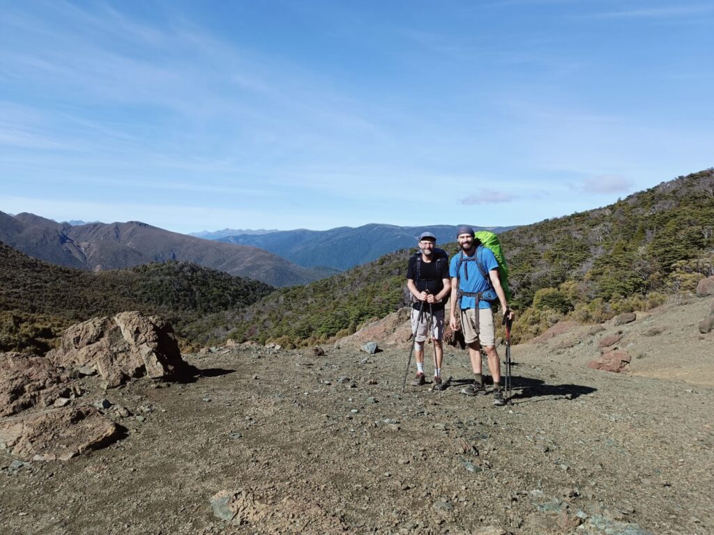 two men hiking on a mountain