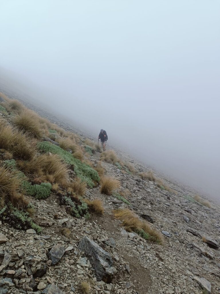 a person walking on a rocky hill