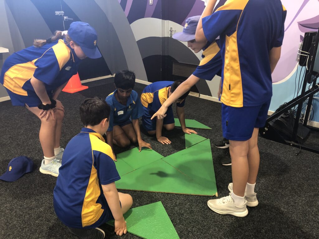 a group of kids in uniform playing a team building game