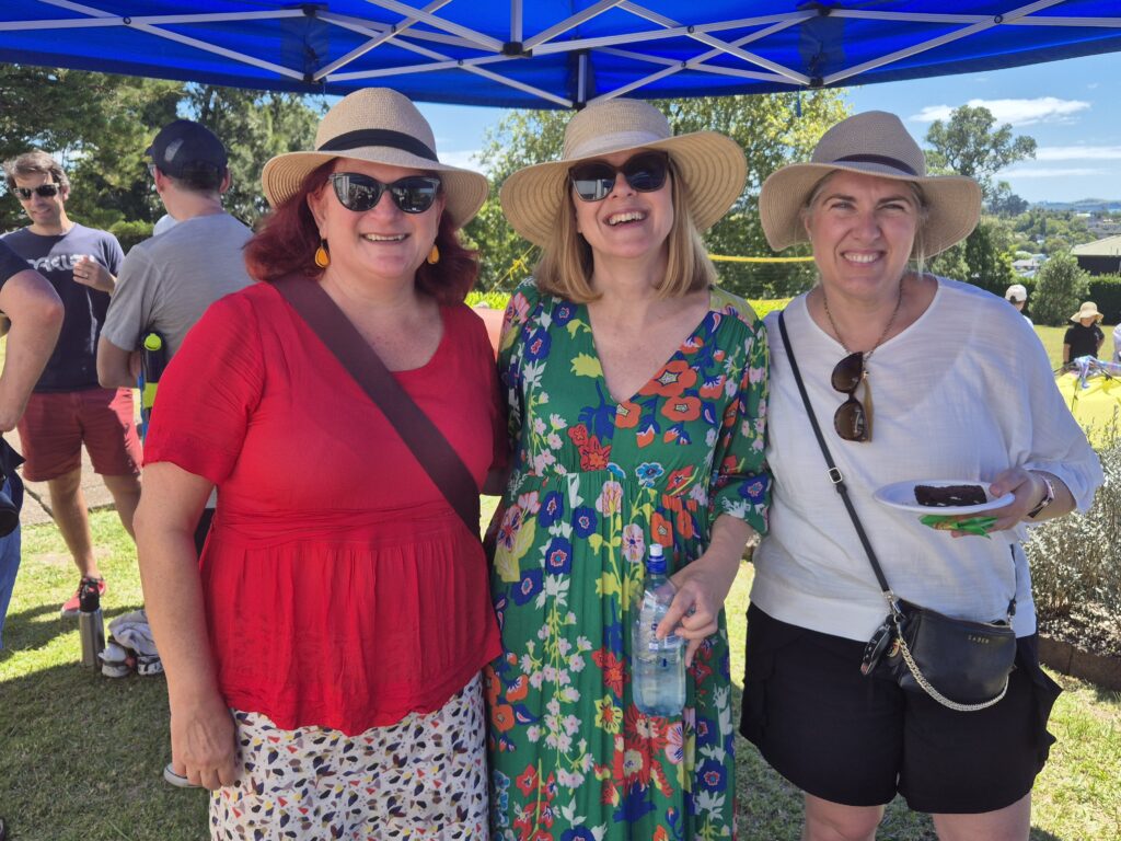 three women wearing sunhats