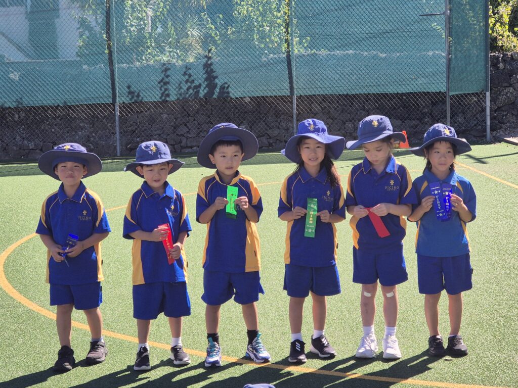 Young children holding coloured ribbons