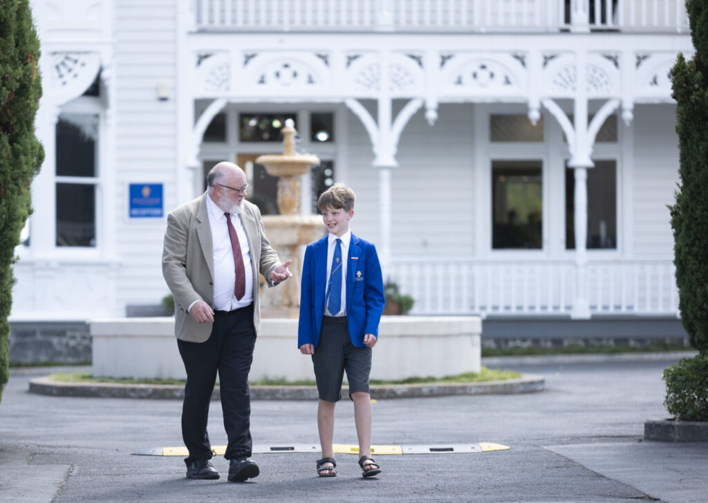 Young male student and male teacher in conversation
