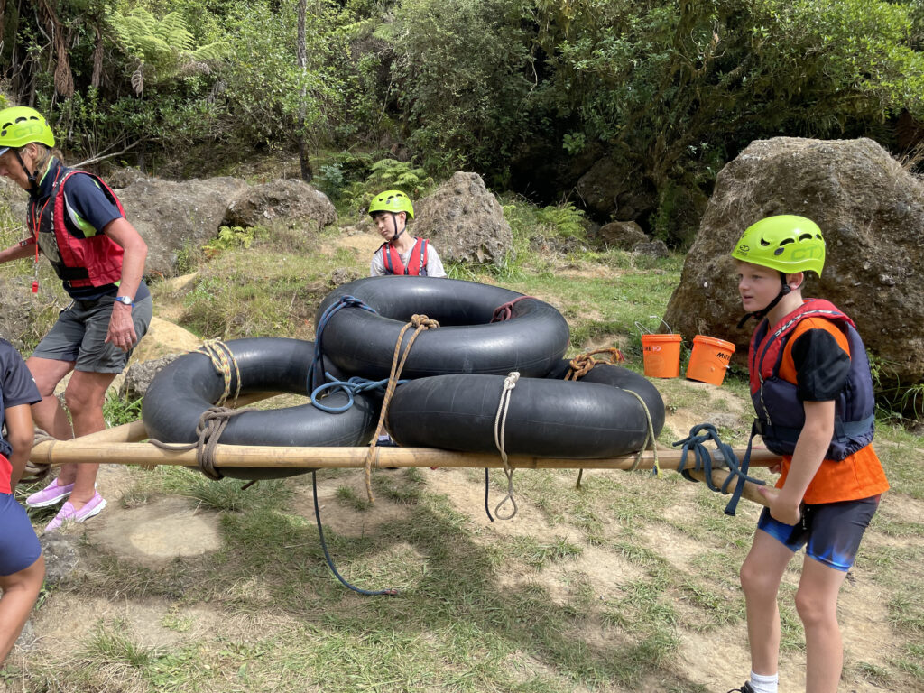 Students carrying inner tubes