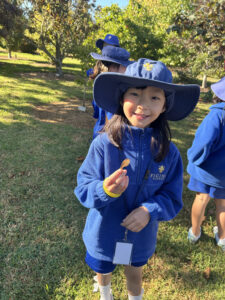 Girl holding leaf in orchar