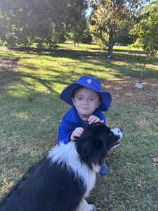 Boy and dog in orchard