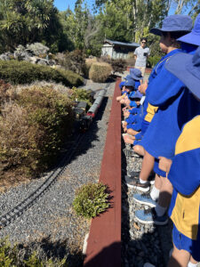 Children watching toy train on tracks