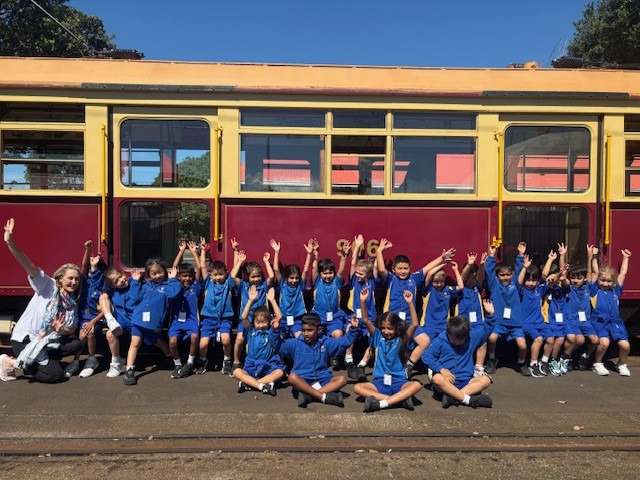 children in front of a tram