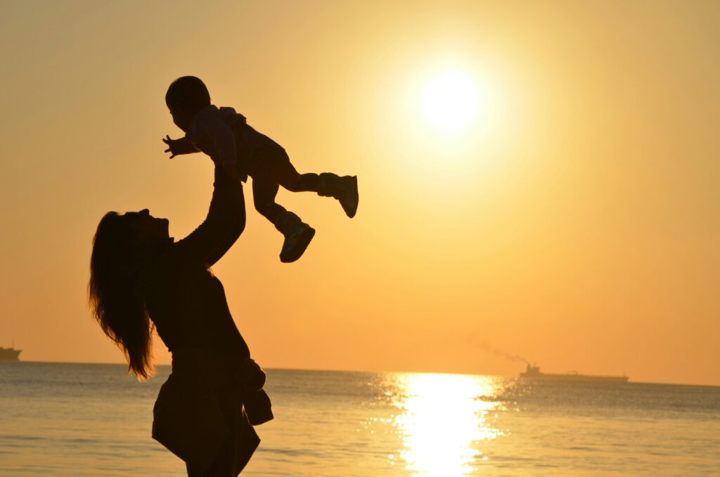 Mother holding child in sun