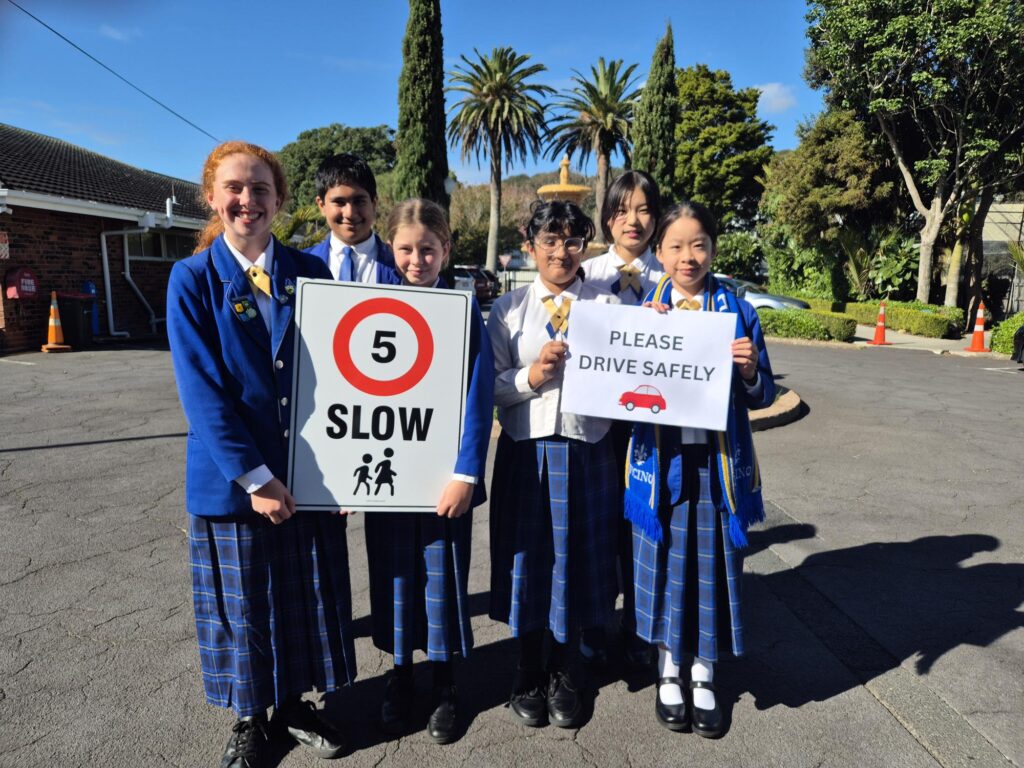 Girls and boys holding speed signs