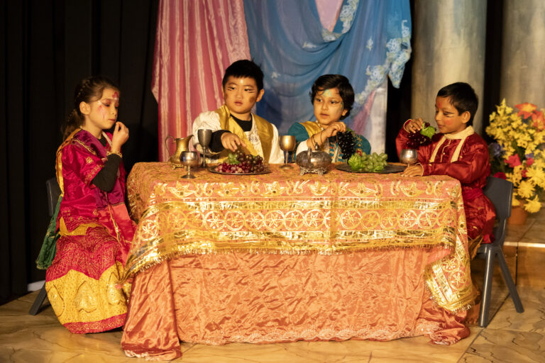 a group of kids sitting at a table