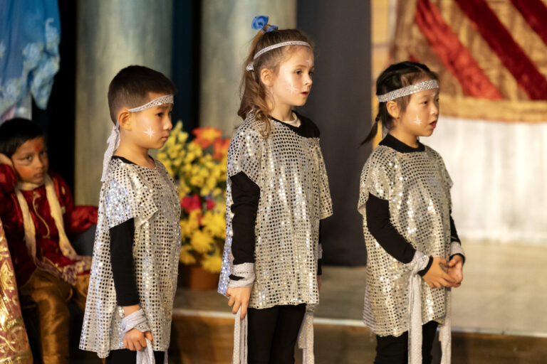 three children dressed in silver
