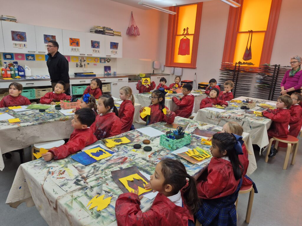 Young children observing art teacher