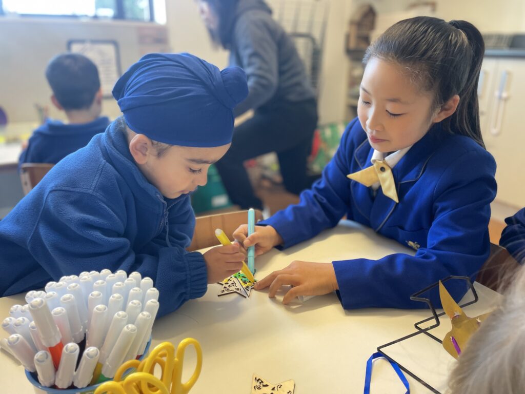 Young children colouring Matariki stars
