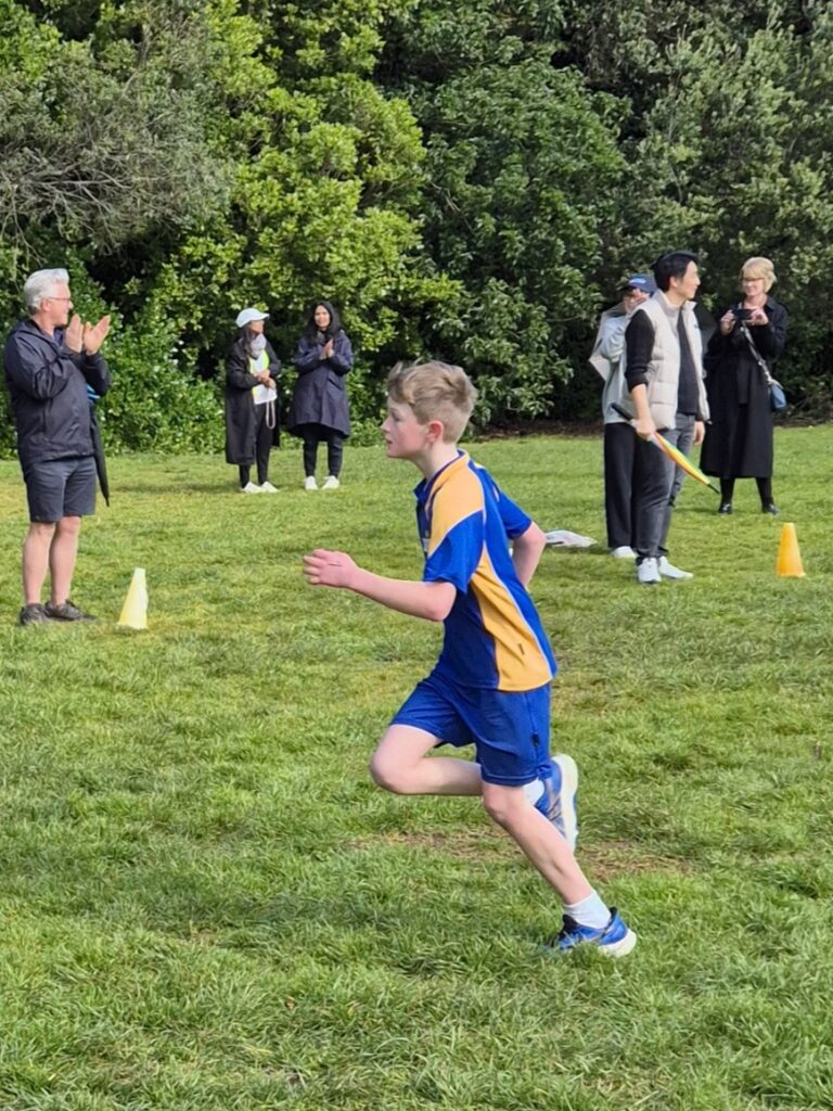 A boy running in a park