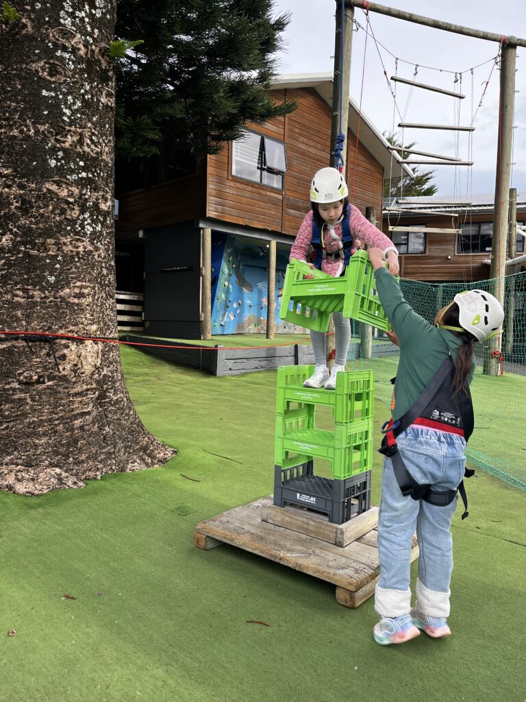 a girl standing on a green crate