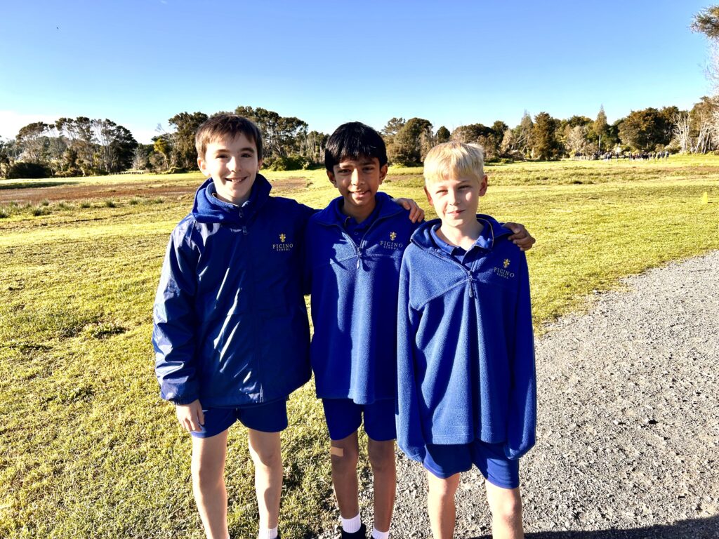 a group of boys in blue jackets standing on a path