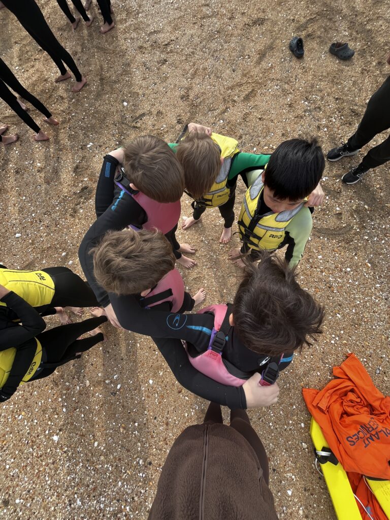 a group of children wearing life jackets