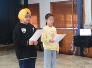 Children read on stage