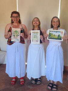 3 woman holding watercolour pictures