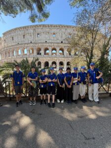 Young children stand outside the Colosseum