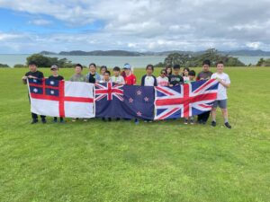 Young children hold flags at Waitangi grounds