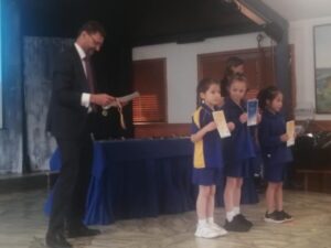 Young primary school children receive prizes on stage