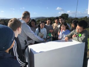 Children look at display sign at Waitangi Treaty Grounds