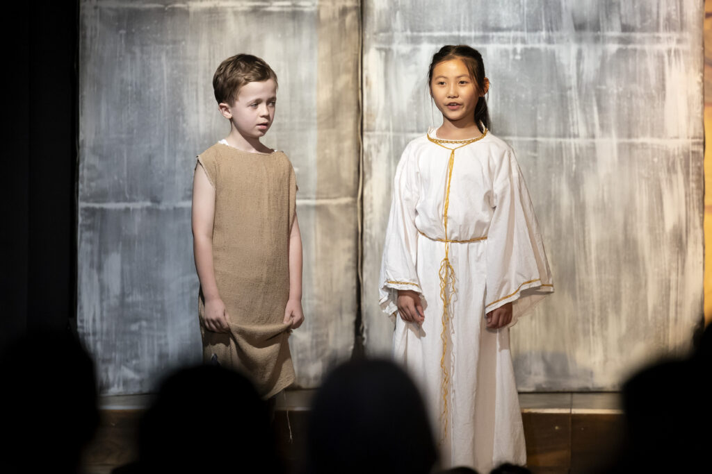 two children dressed in white