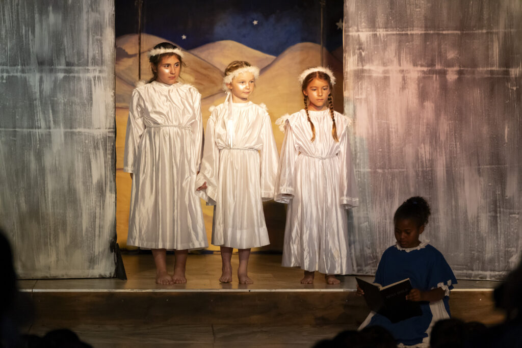 Three girls dressed as angels
