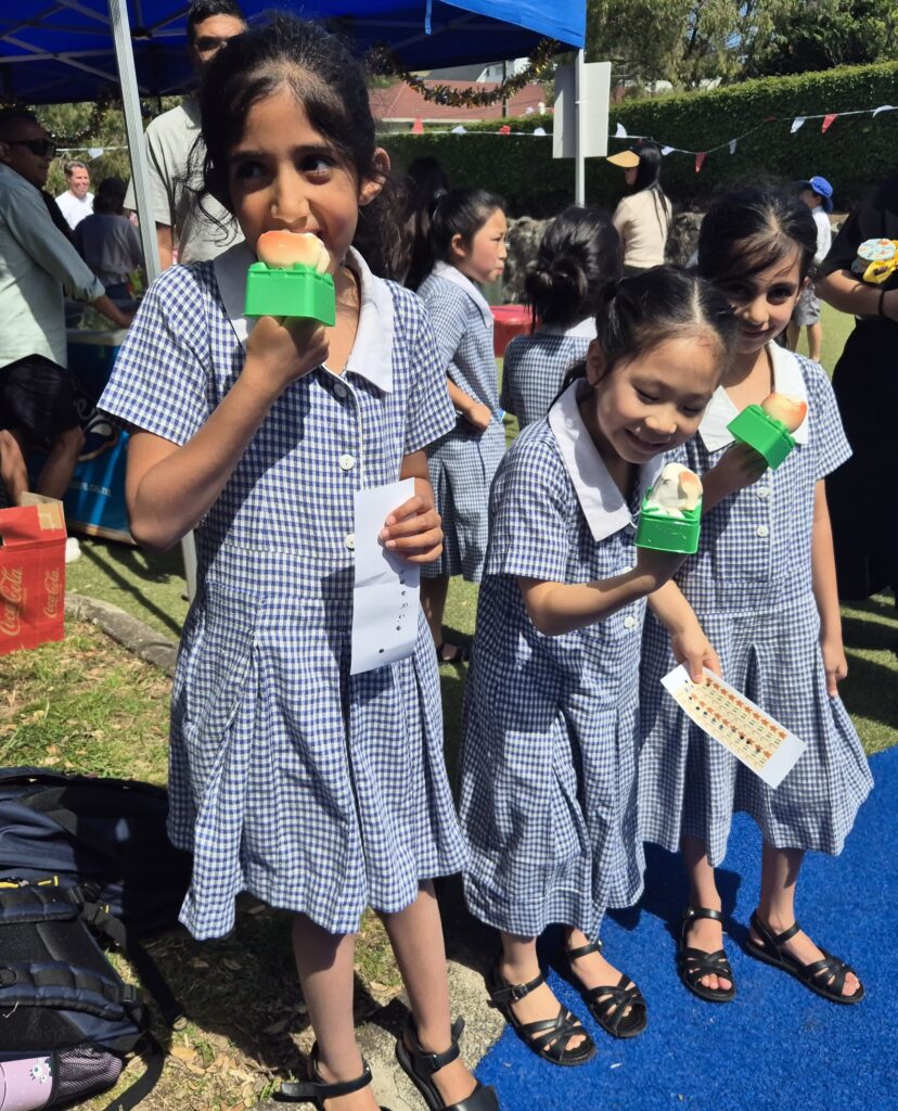 Young school girls eating ice cream