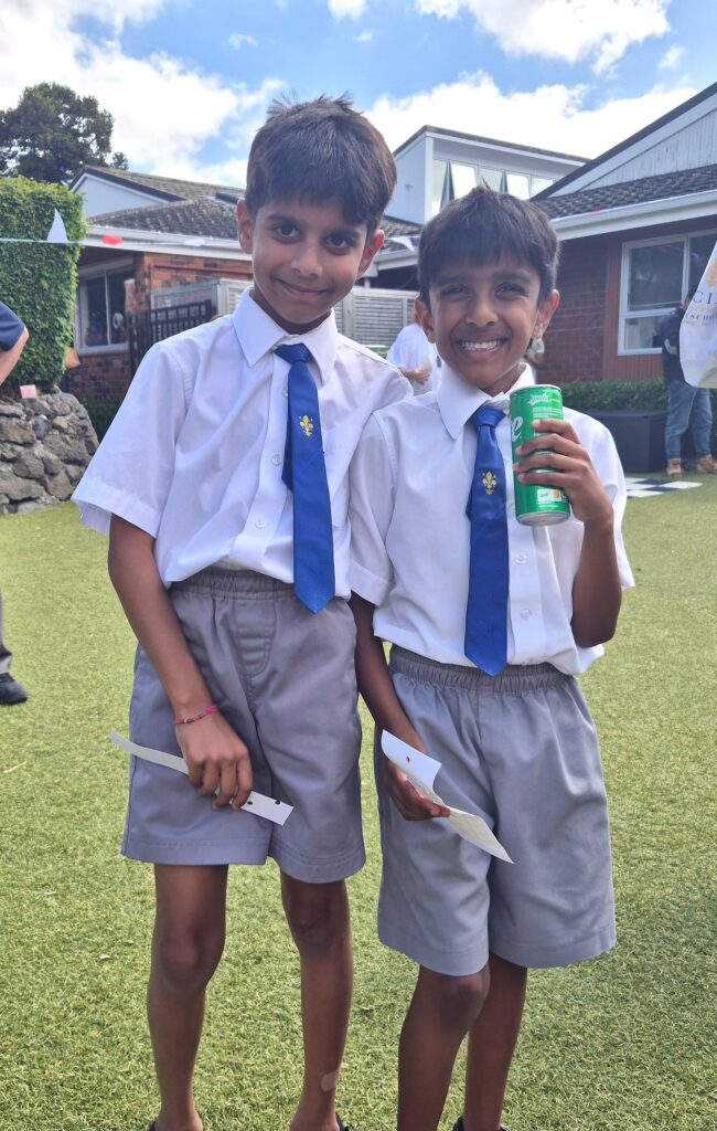 Two young boys wearing ties with their arm around each other