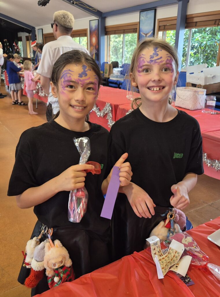Two young girls wearing facepaint