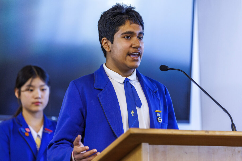 Boy in a blue blazer giving a speech