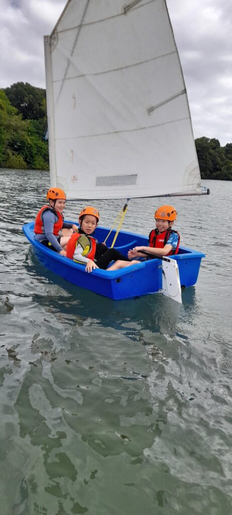 3 young boys in a sailing boat