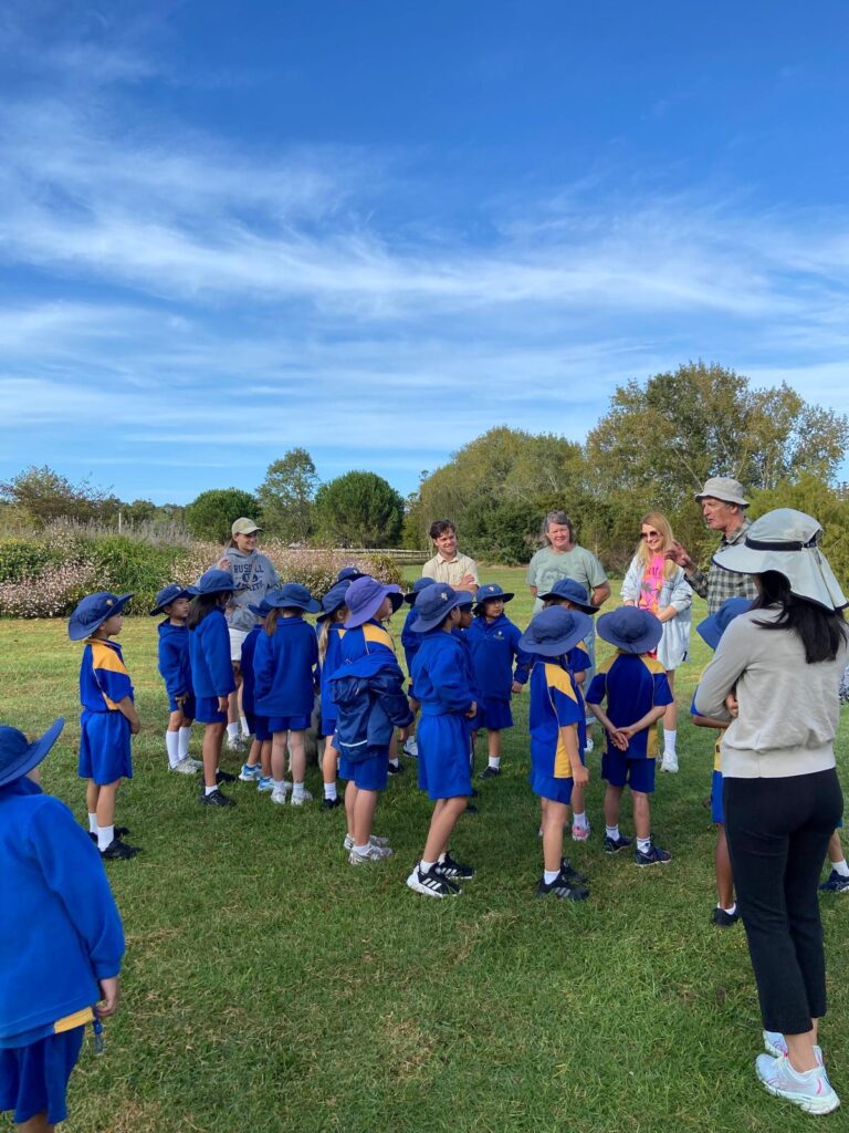 A group of schoolchildren wearing blue uniforms
