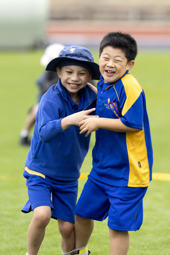 Two schoolboys laughing together