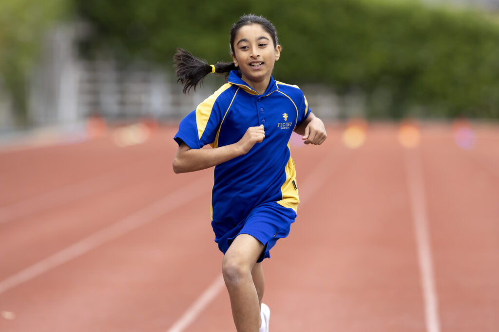 Young Indian girl running on a track