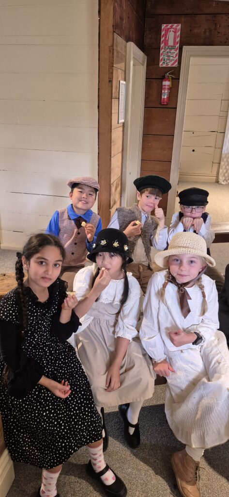 A group of school children in Victorian clothes