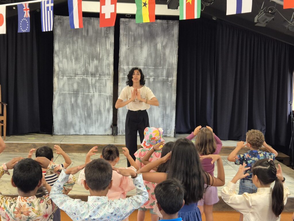 An Indian woman standing in front of a group of children