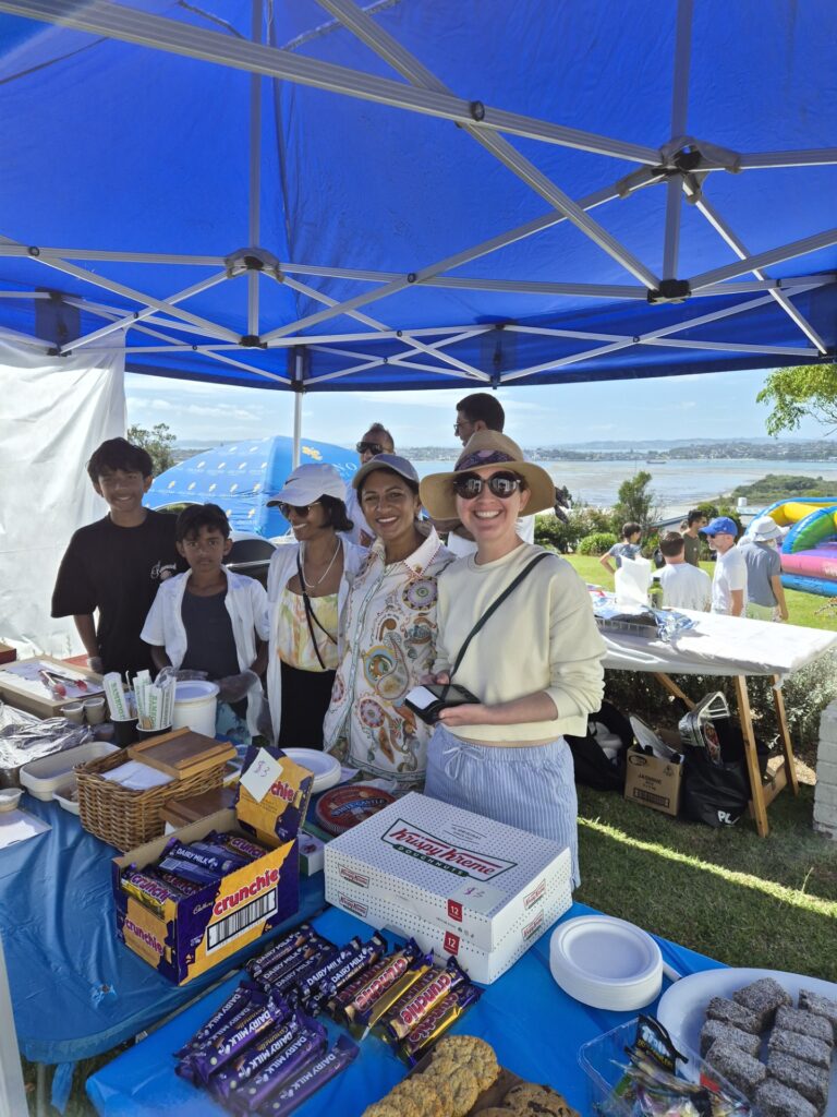 People standing under a blue gazebo