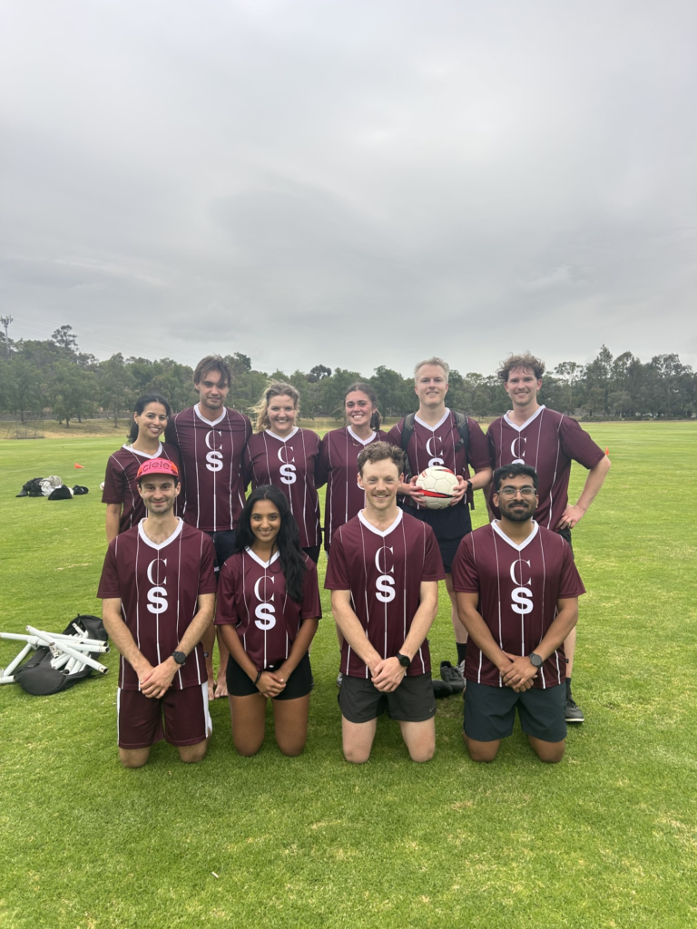 An Austrlian football team wearing burgundy shirts