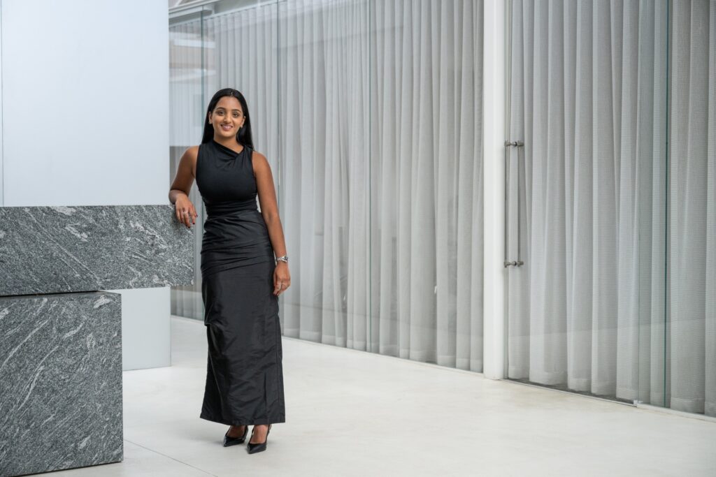 Beautiful young Indian woman wearing a long black dress