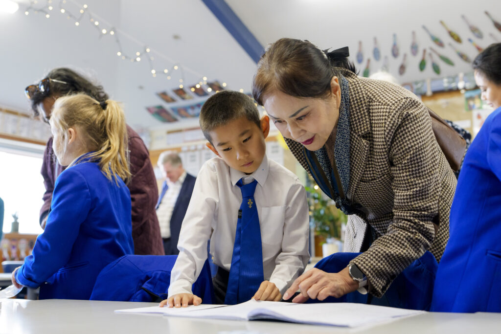 Teacher assisting student with work