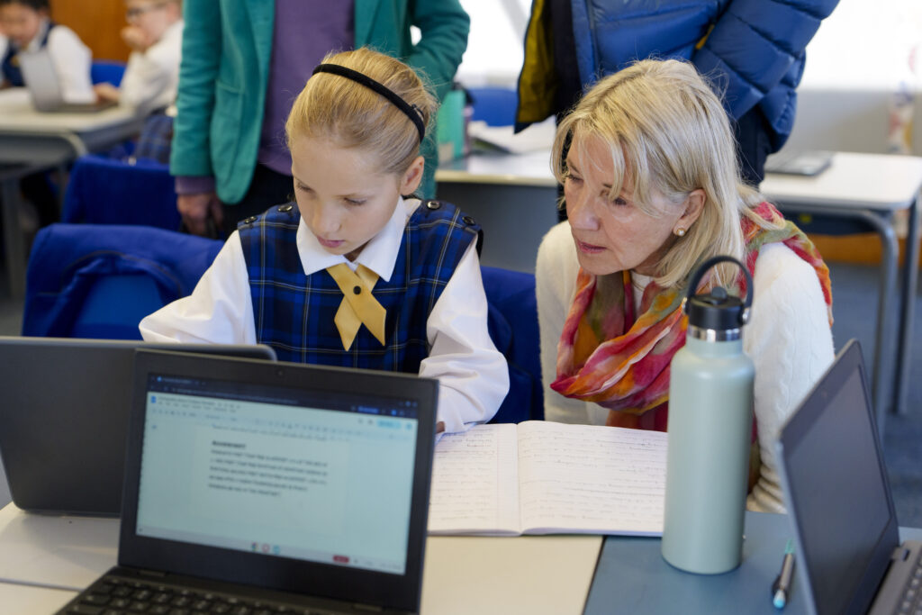 A young girls and old lady looking at a laptopp